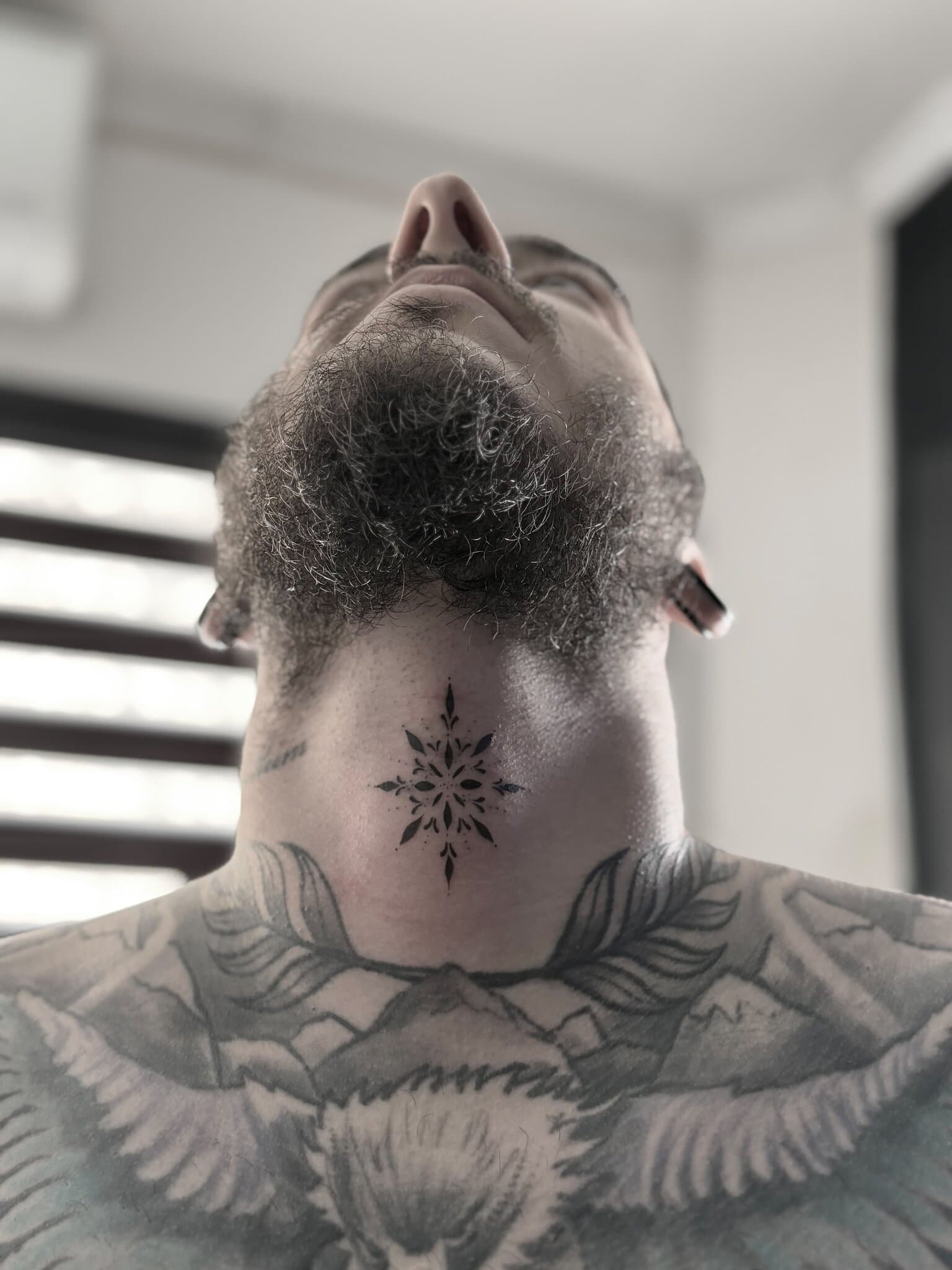 Ornamental mandala centrepiece on the throat, blackwork — by Stefan Buttigieg