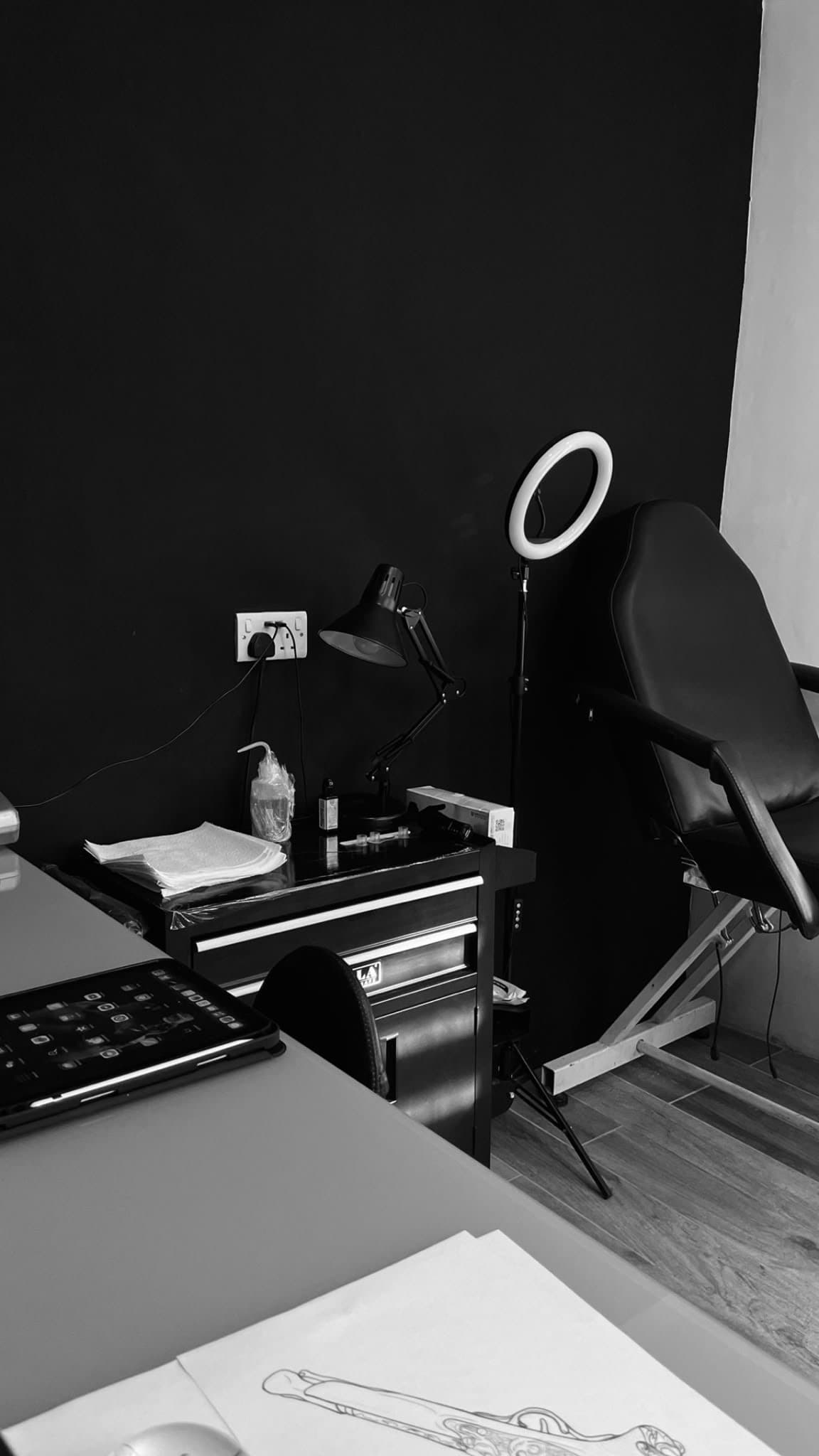 Inside the Ink Alley studio — the single chair, workstation and ring light in Żabbar